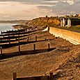 Groynes and huts and cliffs