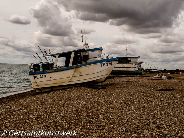 Fishing boats  dark clouds