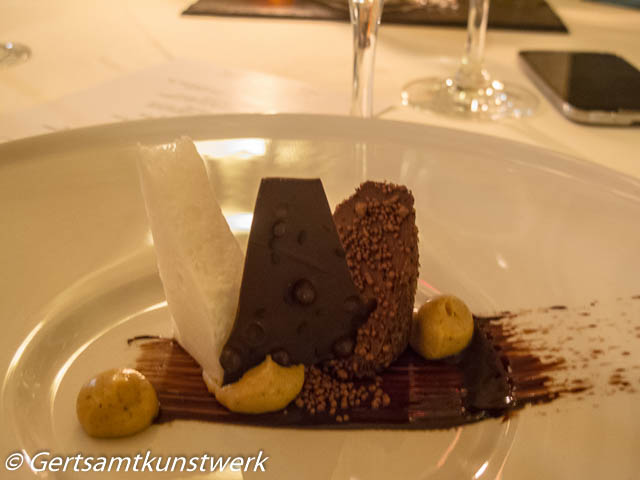 Guanaja Chocolate rolled in Nuts and Sesame Seed Soil, Frozen Rum and Coconut Mousse, Chocolate sauce and Sesame Cream